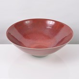 A red stoneware bowl made by Rupert Spira in 1997 sold at auction by Maak Contemporary Ceramics
