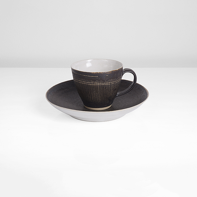 A manganese stoneware cup and saucer made by Lucie Rie in 1976 sold at auction by Maak Contemporary Ceramics