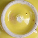 An impressed maker's mark on a yellow porcelain teabowl made by Emmanuel Cooper sold by Maak Contemporary Ceramics