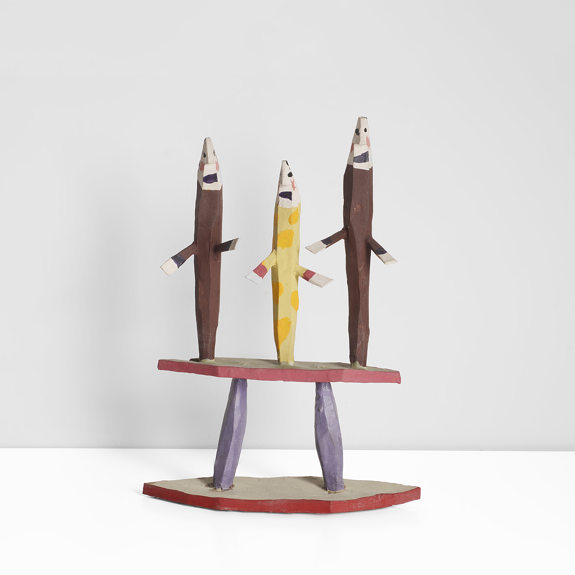 A wooden construction of three figures on a platform made by Bryan Illsley in 1985 sold at auction by Maak