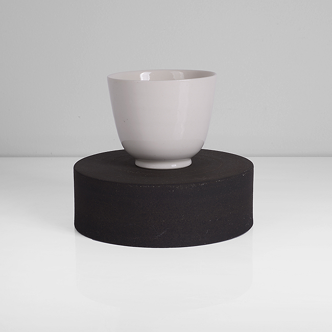 A white porcelain cup on black stoneware ground made by Julian Stair in circa 2017 sold at auction by Maak Contemporary Ceramics