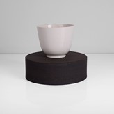 A white porcelain cup on black stoneware ground made by Julian Stair in circa 2017 sold at auction by Maak Contemporary Ceramics