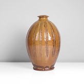 An ochre stoneware vase made by Mike Dodd sold at auction by Maak Contemporary Ceramics