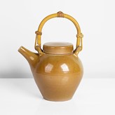 A golden brown porcelain teapot made by Gwyn Hanssen Pigott in circa 1990 sold at auction by Maak Contemporary Ceramics